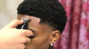 Low taper fade, black male, short hair with waves 