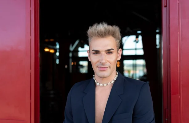Pompadour hairstyle with a retro-inspired top and modern taper on the sides.