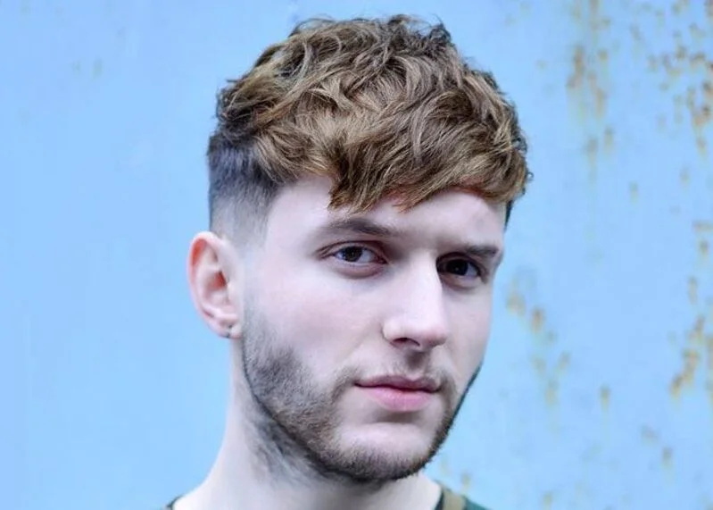 Modern undercut with forward-swept fringe showcasing edgy men's style