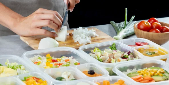 Person practicing batch cooking with healthy food-slow cooker meal prep