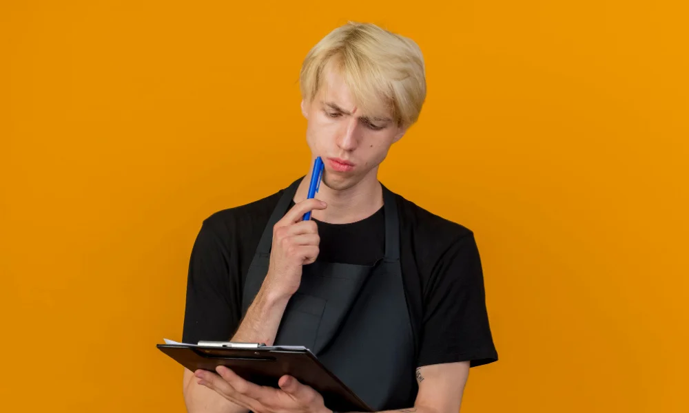Business owner correcting store details on a notepad