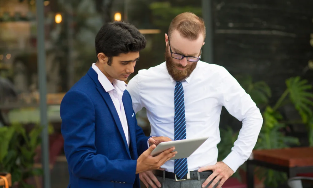 Business owner reviewing SEO pricing packages with marketing agency representative