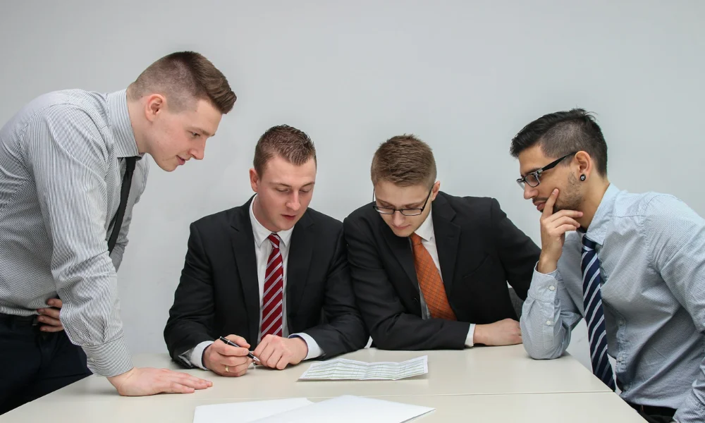 Business owner reviewing notes with staff in office
