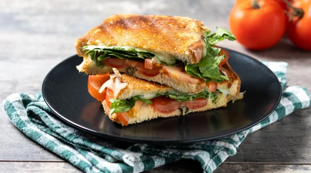 Healthy spinach tomato and cheese sandwich on wooden table-cheap and easy dinner recipes