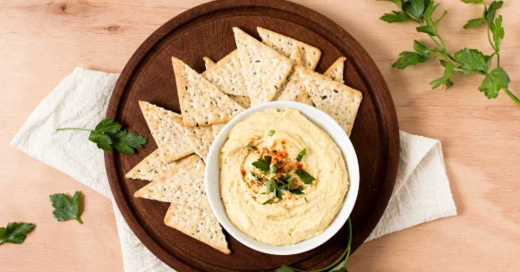 Top view of nacho chips with hummus