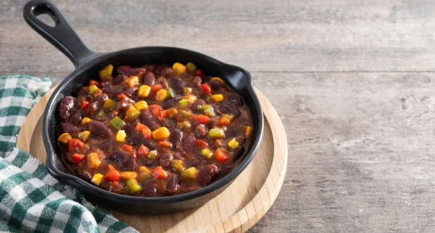 Mexican chilli beans with vegetables in iron pan