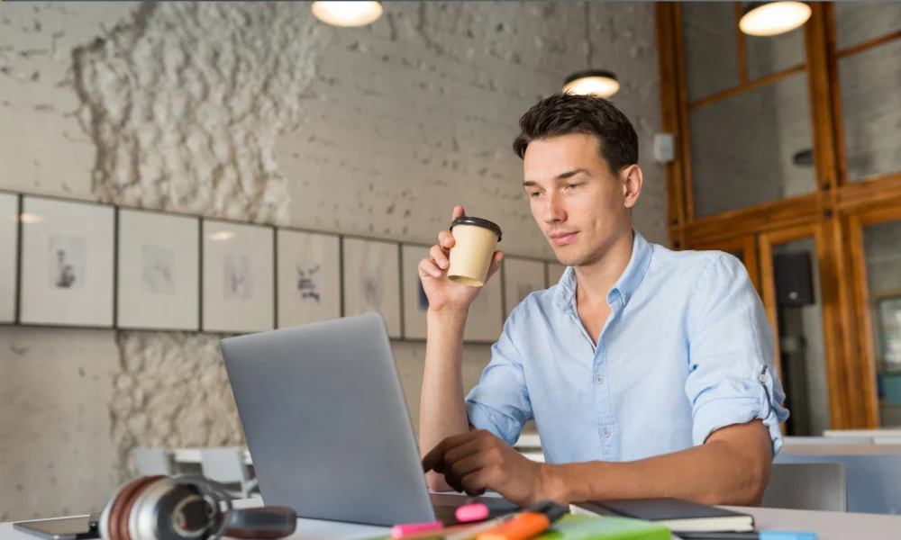 Content creator researching trending topics on laptop in a café