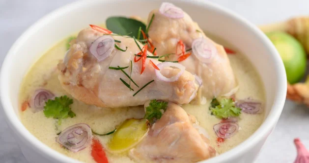 a bowl with kaffir lime leaves, lemongrass, red onion