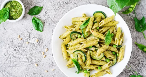 Penne pasta with pesto sauce, zucchini, green peas and basil-cheap pasta recipes