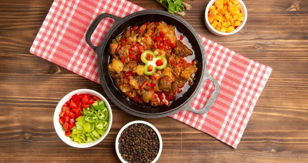 cooked vegetable meal including vegetables sauce and meat inside on brown desk-crockpot recipes for potluck