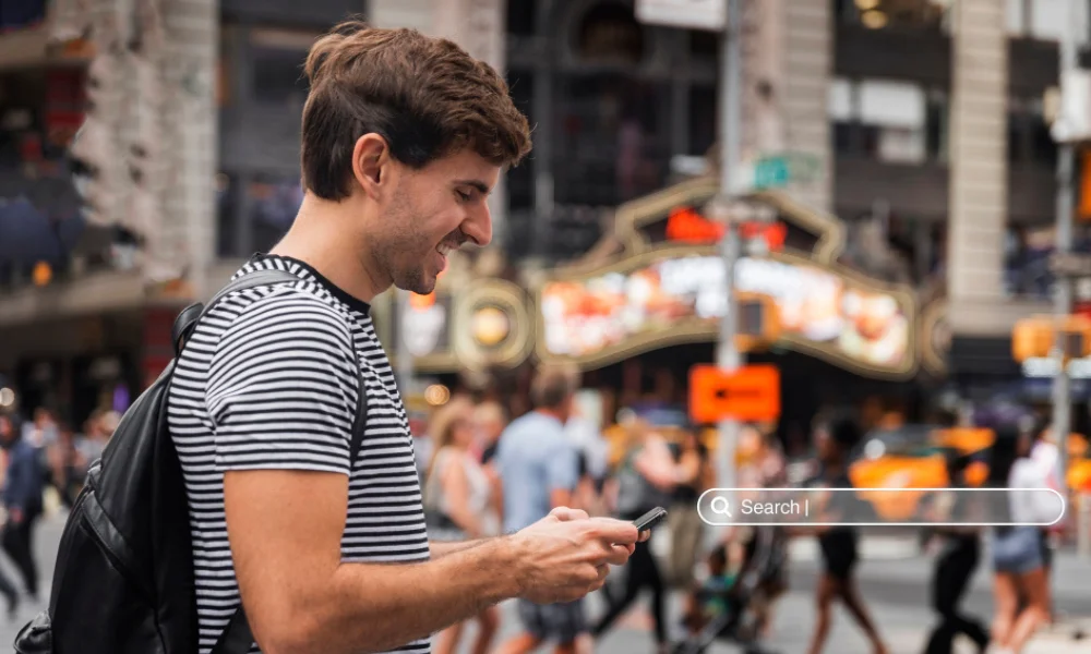 Customers using mobile phones to search for local businesses in city center