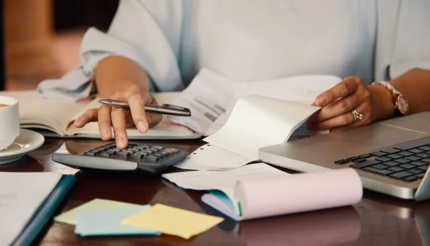 Entrepreneur working with bills Calculator