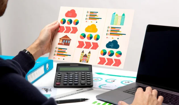 A person holds paper with drawings