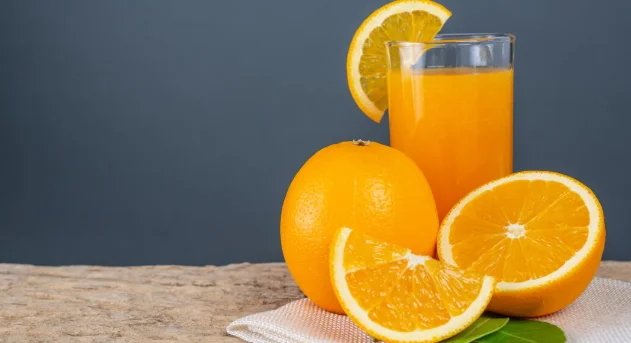 Glass of orange juice placed on wood-best brunch menu