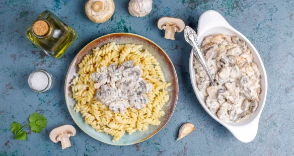 Fusilli pasta with mushrooms and chicken, top view