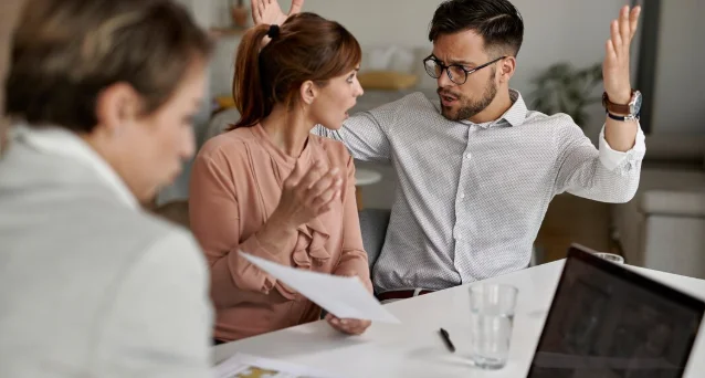 Young displeased couple arguing while having a meeting-applicant interview questions to ask