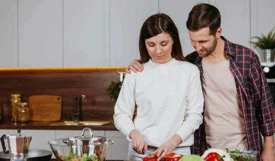 Front view of woman and man preparing food in the kitchen-small crock pot recipes