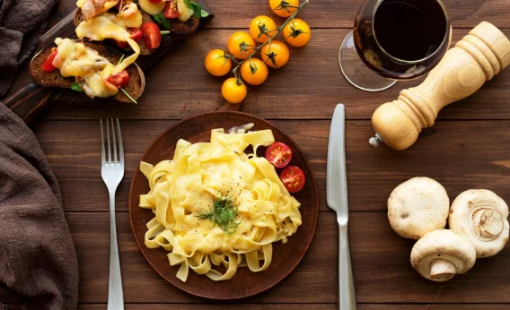 Top view of raclette dish with ingredients and delicious food-inexpensive pasta recipes