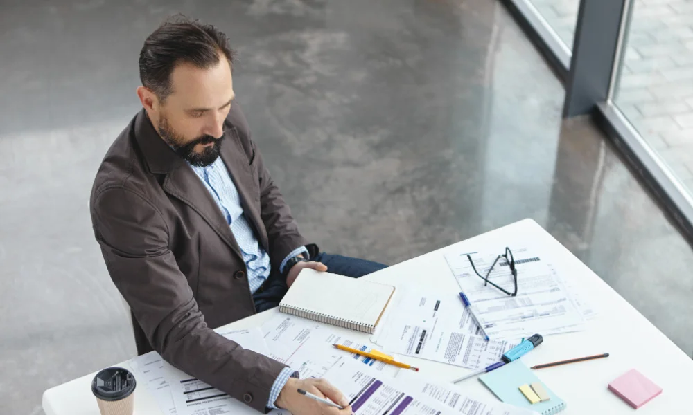 Manager reviewing agency proposals and case studies to choose the right SEO outsourcing partner.