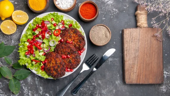 Top view tasty meat cutlets with seasonings on grey background photo food dish-cheap meatless recipes