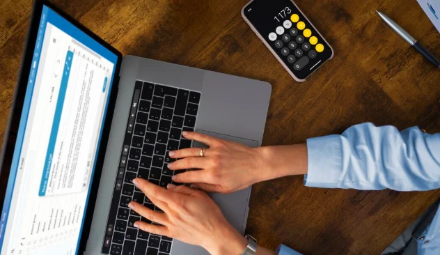 Top view woman typing on laptop-Bills Calculator