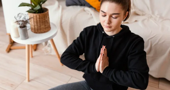 Woman meditating indoor-how to improve yourself daily