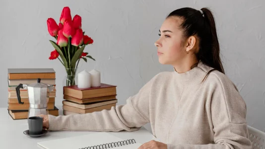 Medium shot woman sitting at table-how to improve yourself daily