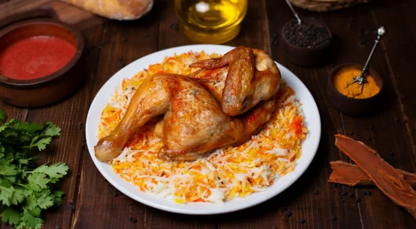 Whole chicken grill served with rice garnish in white plate-cheap family meal