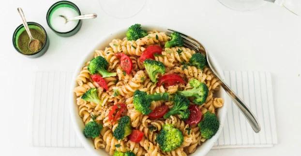 Fusilli pasta salad with tomato and broccoli on napkin-cheap pasta recipes