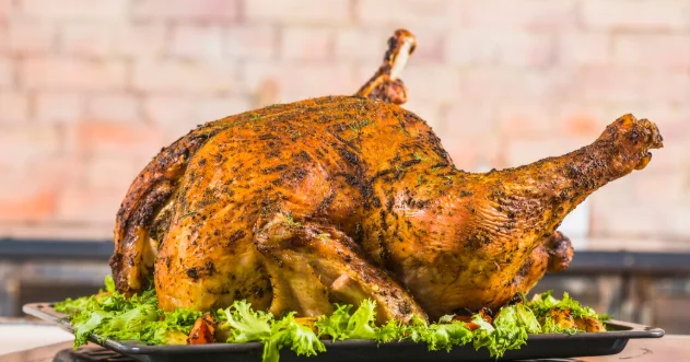 Baked turkey with lettuce on pan