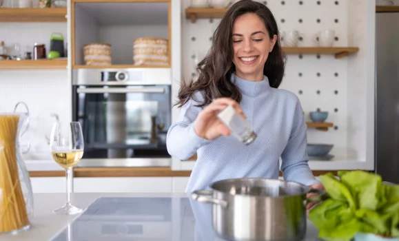 Woman preparing meal in the kitchen-crock pot pressure cooker