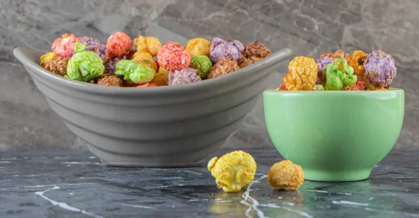wo bowls of colorful tasty popcorns on marble surface-small crock pot recipes