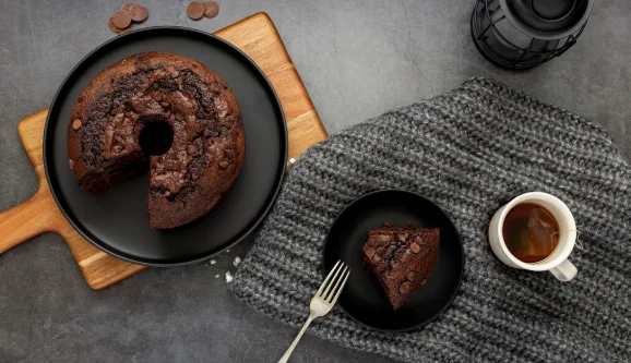 Chocolate cake and a slice of cake with a cup of coffee-crockpot potluck ideas