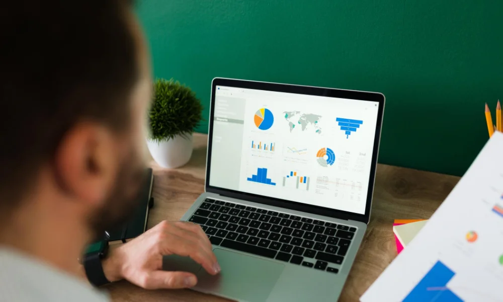 A digital marketer analysing SEO analytics dashboard on a computer screen.