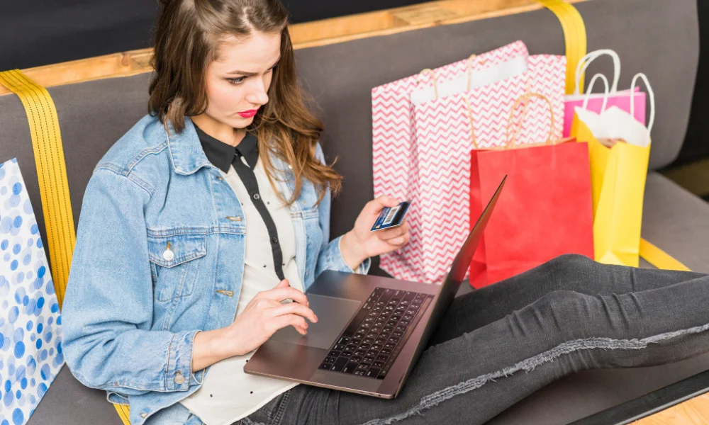 Blogger working on laptop with shopping bags and Target logo nearby
