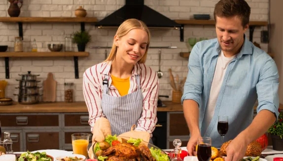 Lovely couple preparing the dinner food in the kitchen