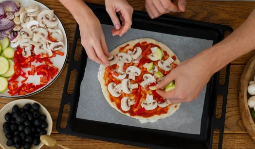 Top view cook preparing pizza