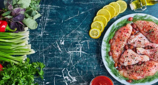 Raw spicy chicken pieces in a white plate