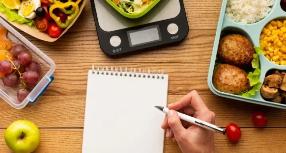 Top view tasty meal arrangement with empty notebook-family meals