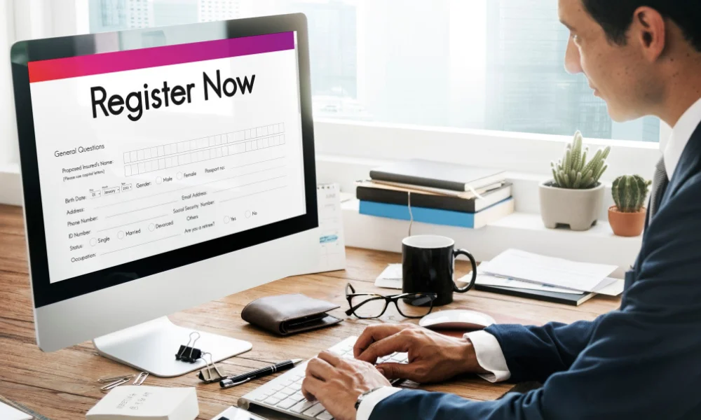 Professional filling online application form on laptop.