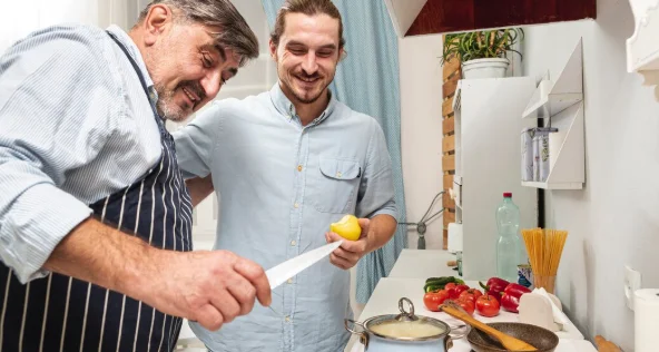 Father holding a knife and son a delicious apple-slow cooker recipes for two