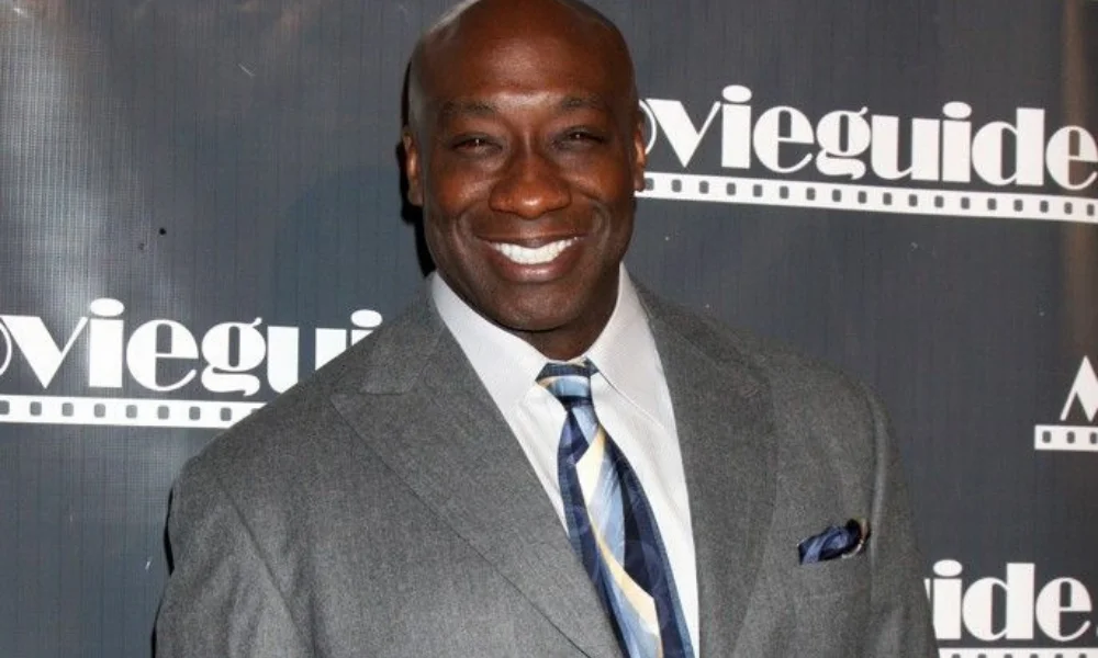 man in a grey suit-michael clarke net worth