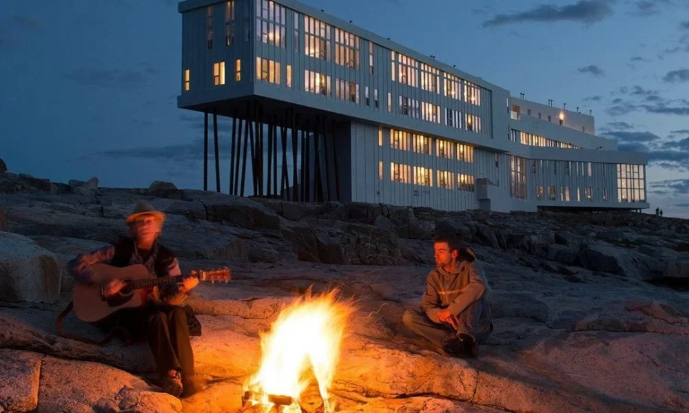 Nighttime campfire outside luxury stilt hotel for Most Exclusive Travel Destinations.
