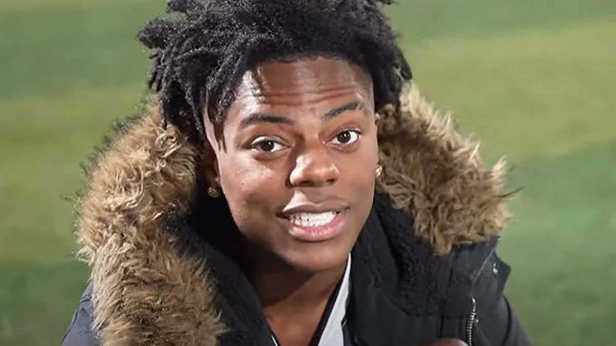 Streamer IShowSpeed speaking in a fur-trimmed winter jacket outdoors.