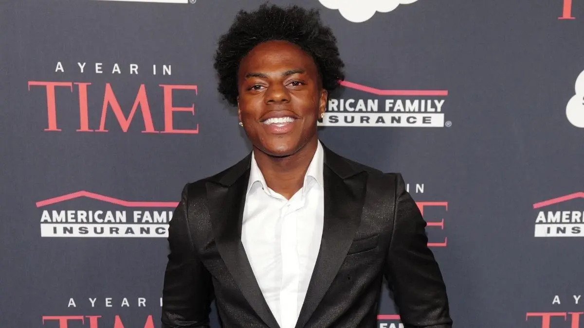 Streamer IShowSpeed smiling in a suit against a TIME event backdrop.