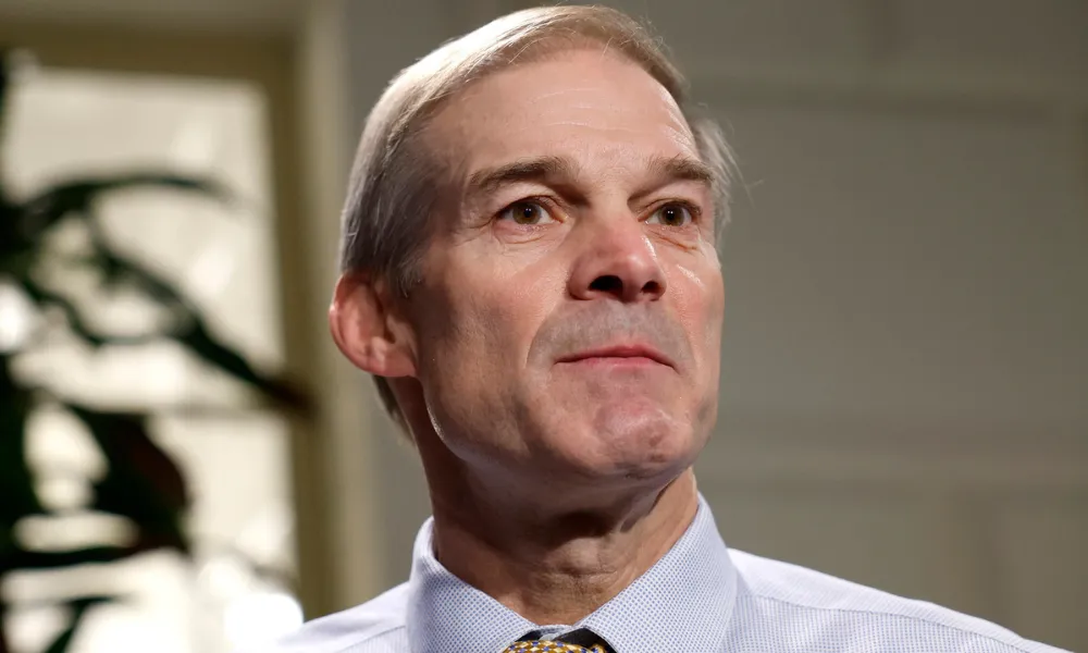Jim Jordan wealth net worth 2026 context featured in a close-up portrait of U.S. Representative Jim Jordan wearing a blue dress shirt and patterned tie.