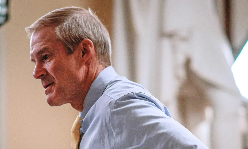 Jim Jordan wealth net worth 2026 context featured in a side-profile view of U.S. Representative Jim Jordan wearing a light blue dress shirt and yellow tie.
