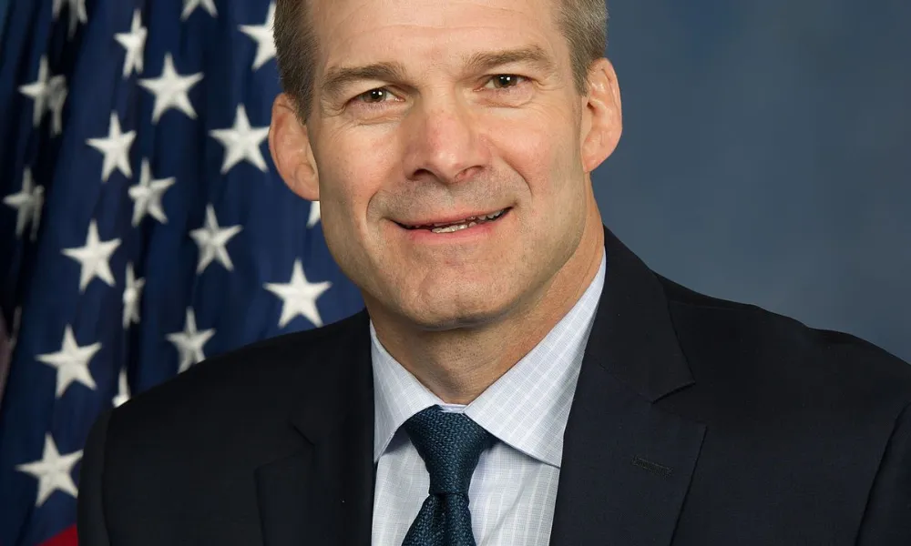 Jim Jordan wealth net worth 2026 context featured in an official portrait of U.S. Representative Jim Jordan smiling in front of the American flag.