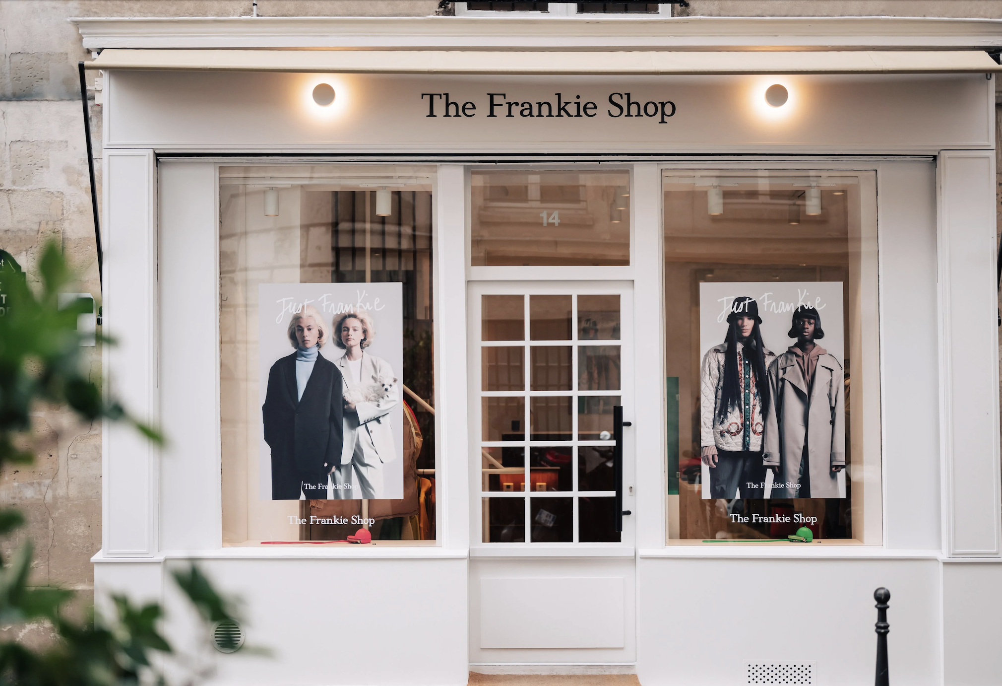Exterior storefront of The Frankie Shop boutique with white window frames and posters displayed in the windows.
