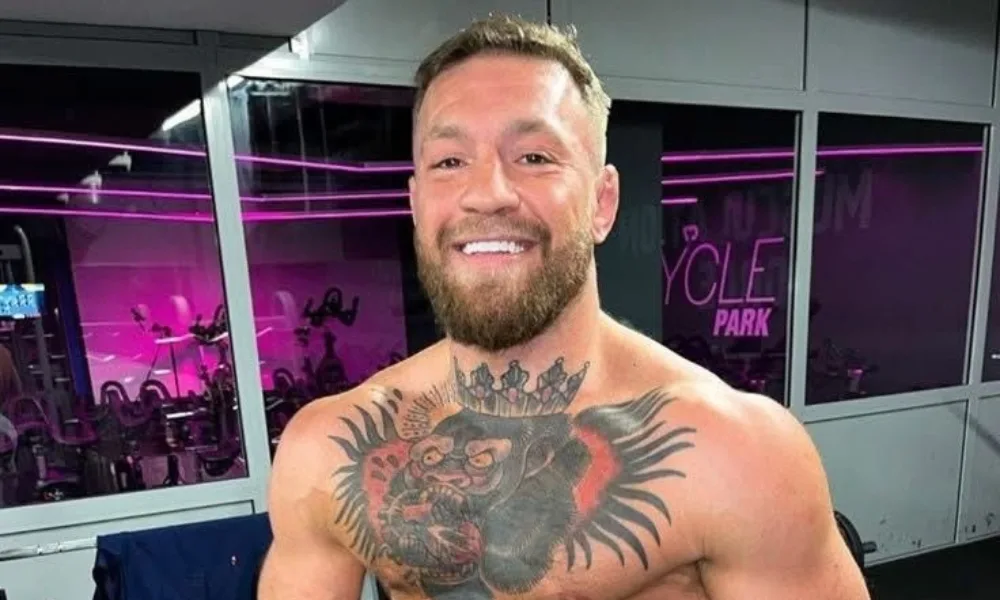 Alt Text: Conor McGregor posing after a gym workout featuring conormcgregor networth.